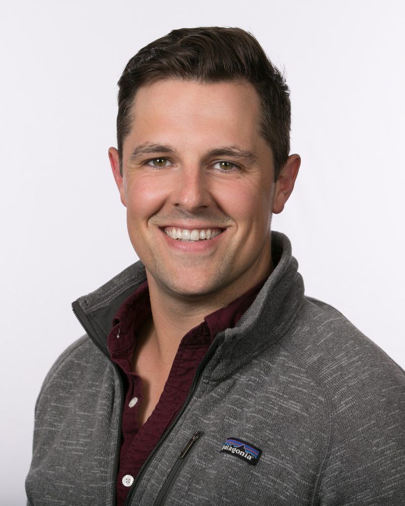 James O'Connor smiling, wearing a gray fleece